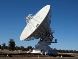Large satellite dish against a clear blue sky.
