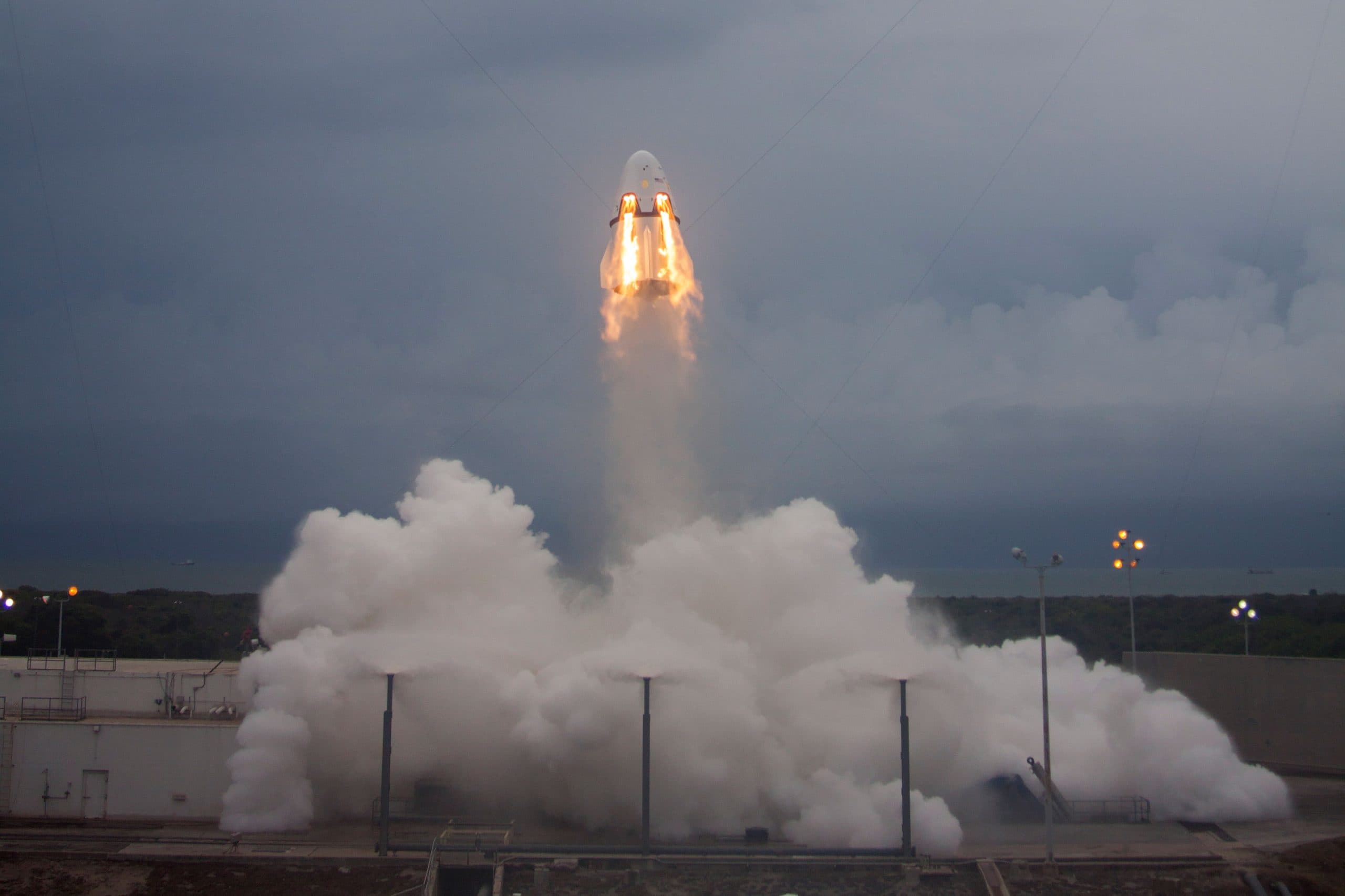 A SpaceX rocket launching with smoke and flames.