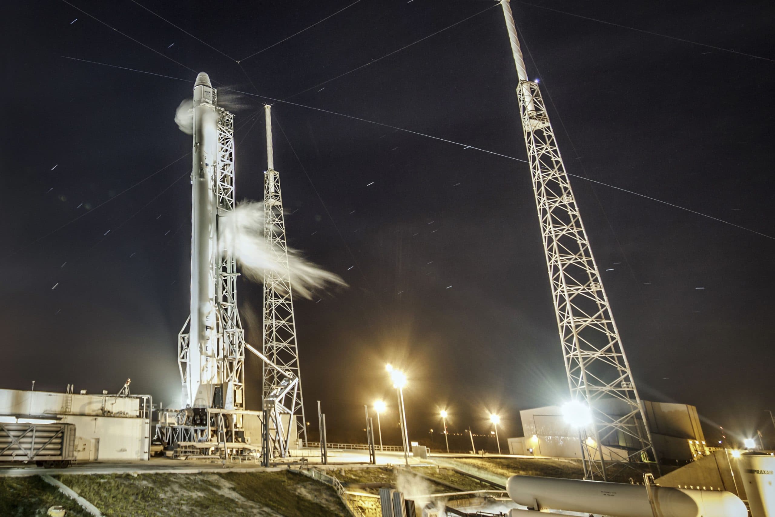 Falcon 9 rocket preparing for launch at night.