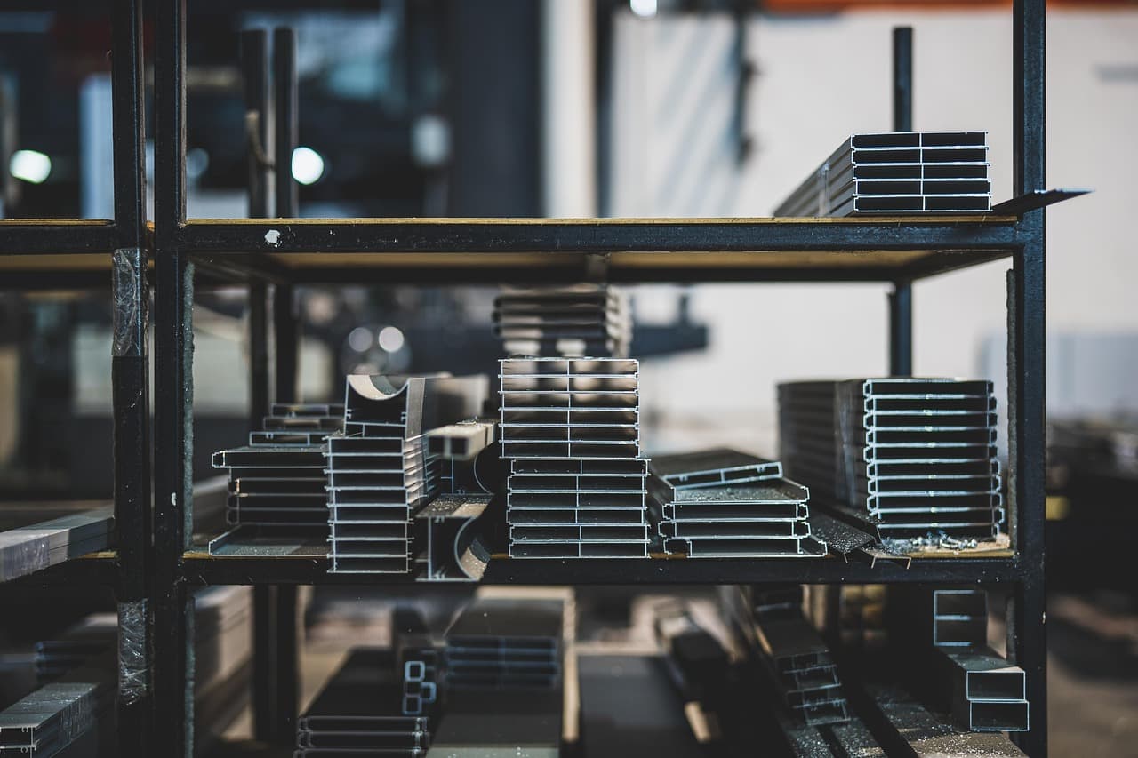 Metal profiles stacked on industrial shelves.