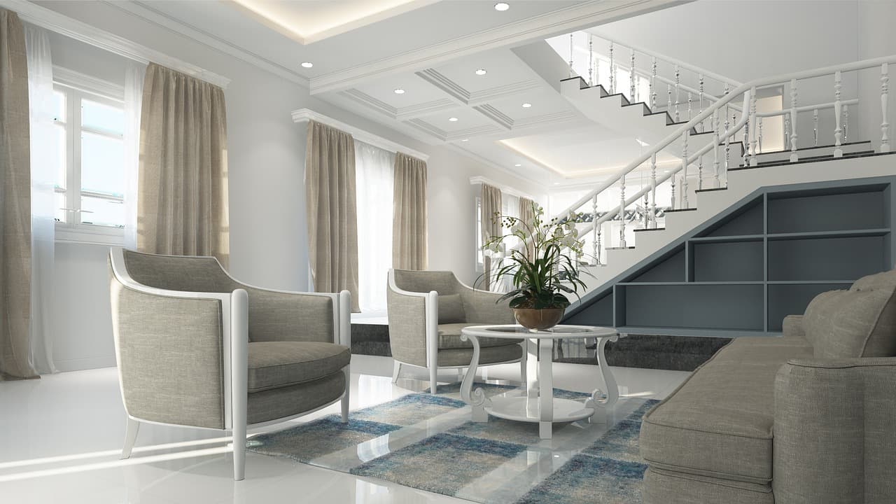 Modern and luxurious living room with elegant furniture and staircase.