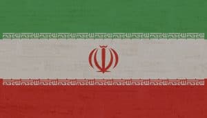 Irans flagga mot en texturerad bakgrund.