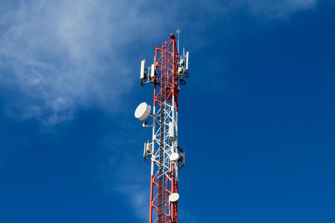 Telecommunication tower against a blue sky.