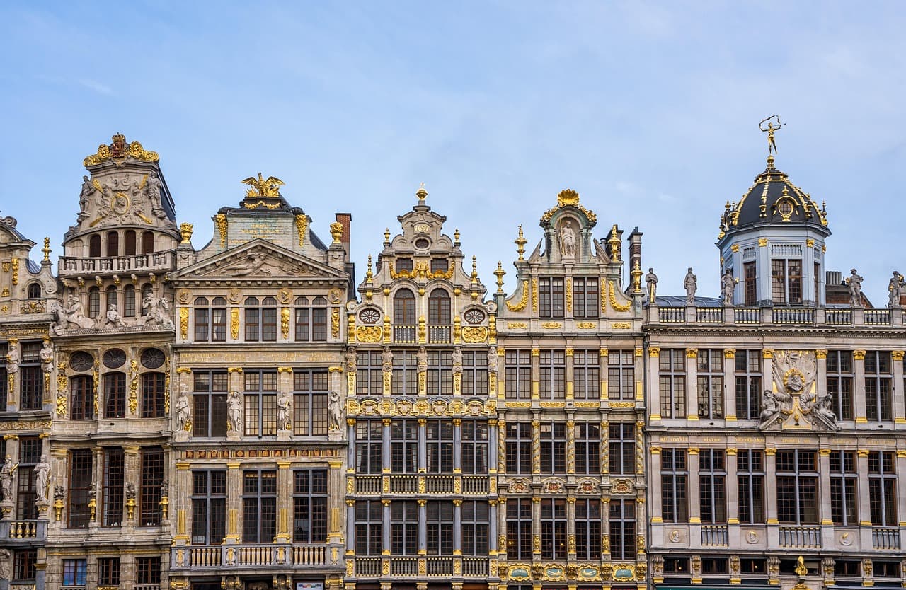Historic European buildings with ornate facades under a blue sky.