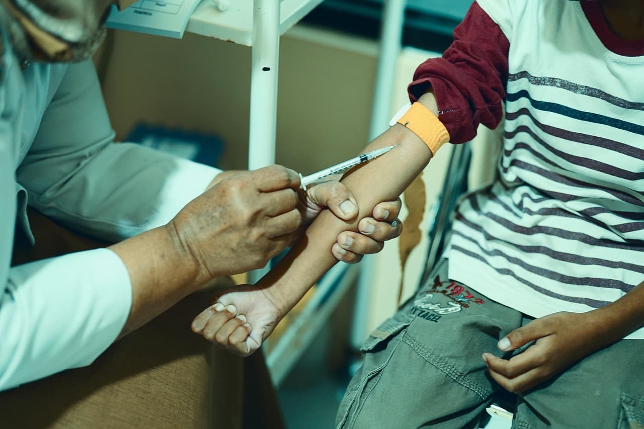 A healthcare professional administering an injection to a patient's arm.