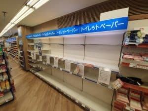 Tomma hyllor i en butik där toalettpapper och näsdukar vanligtvis säljs.