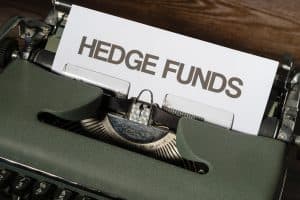 A typewriter with a paper labeled 'Hedge Funds'.