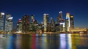Skyline of a city with illuminated skyscrapers at night.