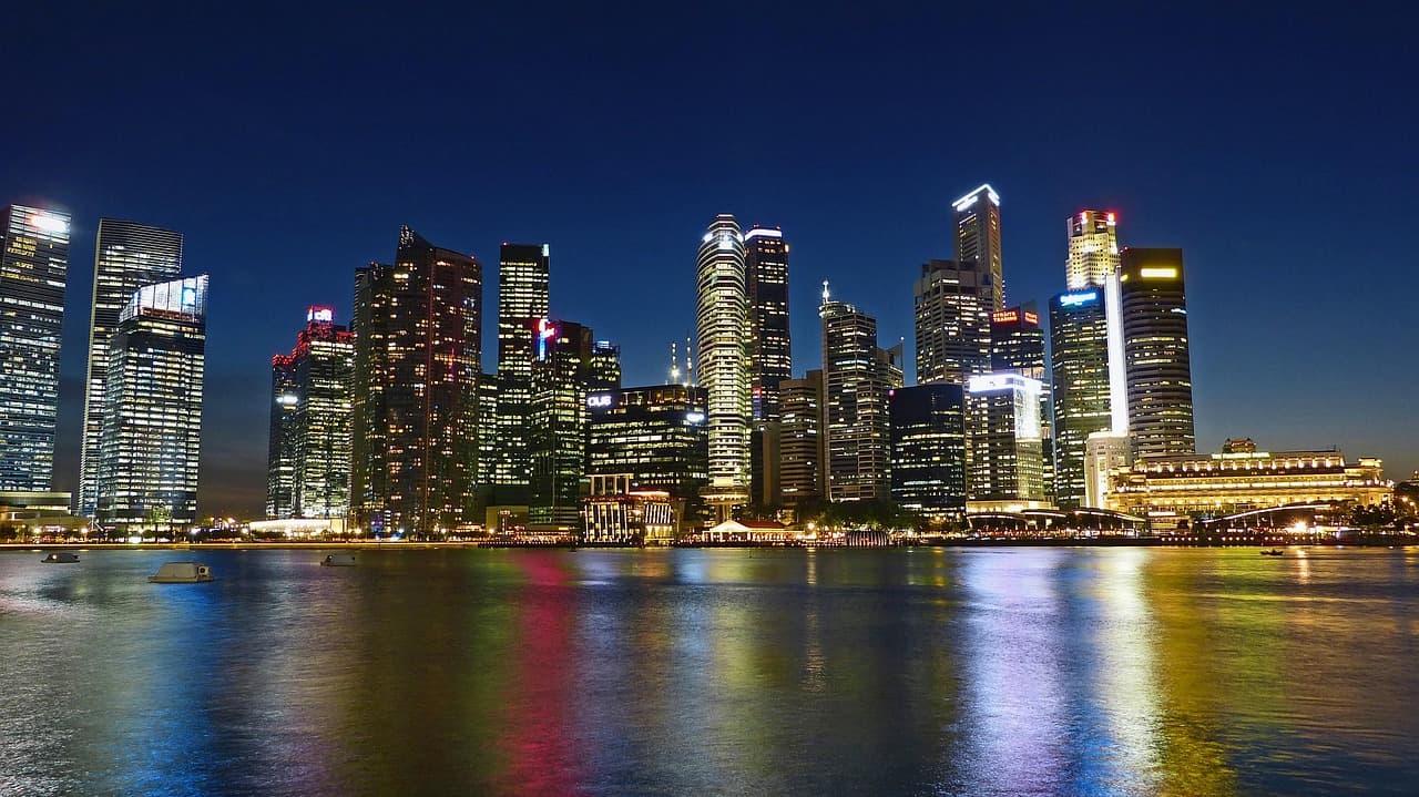 Skyline of a city with illuminated skyscrapers at night.