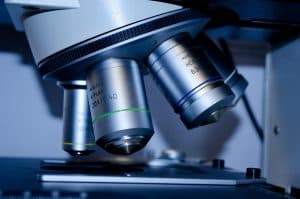 Close-up of a microscope in a laboratory setting.
